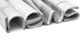 Newspapers folded to form the word NEWS