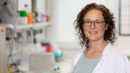 EB house researcher stands in the lab and looks at the camera