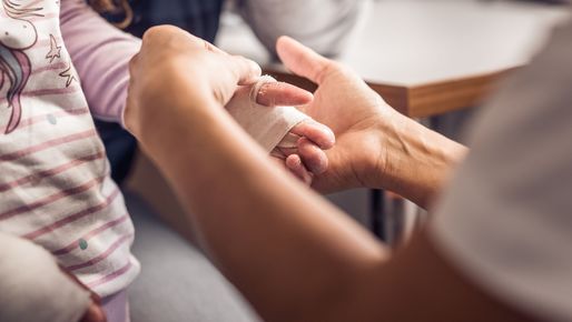 Doctor examines the hand of an EB patient