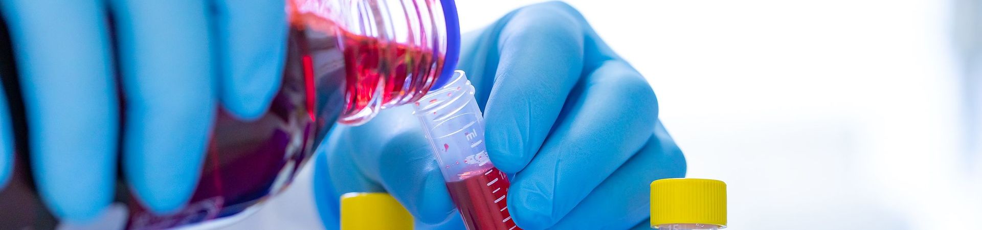 EB researcher mixes various liquids in test tubes. 